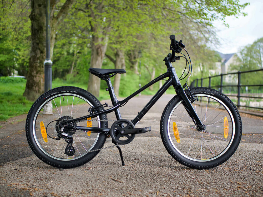 Specialized Jett Childrens bike review a photo of the bike leant up on its stand by a river