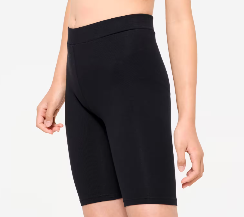Best kids cycle shorts: a girl wearing black fitted non-padded PE shorts