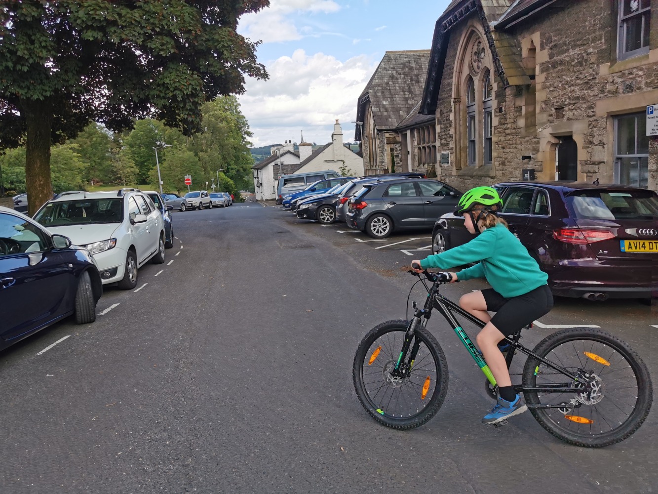 How to start cycling your kids to school- a girl riding in her school uniform