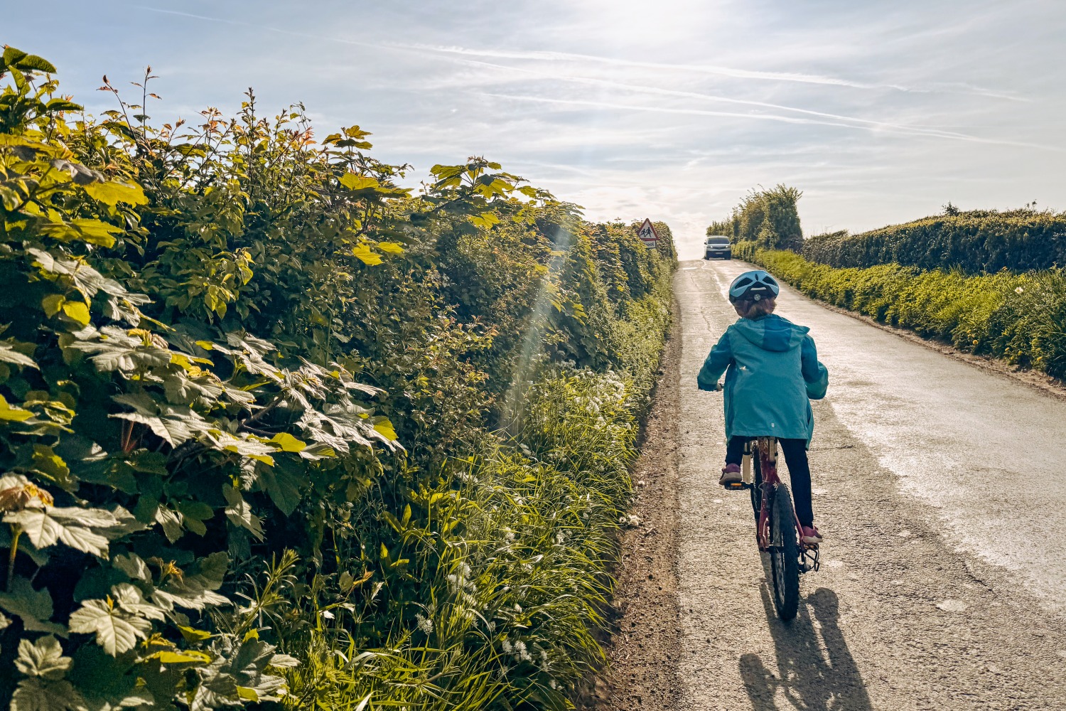 cycling to school- a girl riding in her school uniform