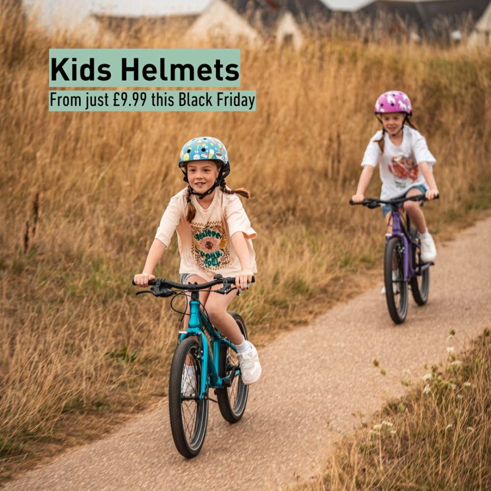 Hornit black friday deal: Two little girls cycling along a path, wearing Hornit helmets, and a badge stating that Helmets are reduced to £9.99