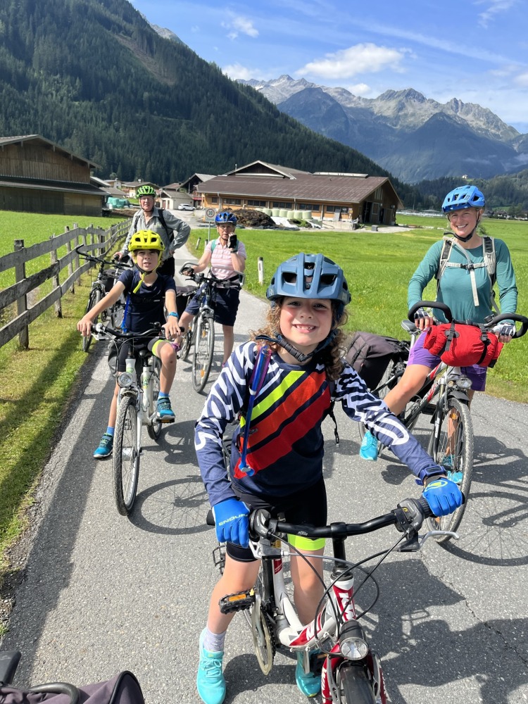 family cycling routes in Austria & italy: A cycling family photo of Bea, her partner, their children, and their grandparents