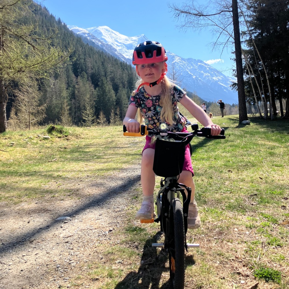 BTWIN 16 Discover 900 review- a girl in a flowery top riding her blue bike