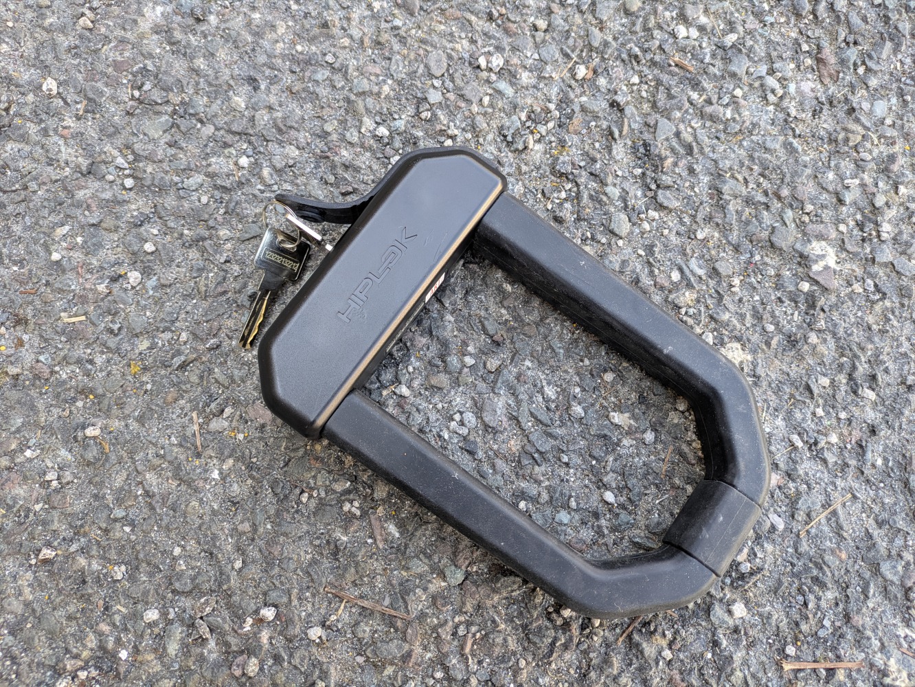 a black Hiplock D1000 bike lock on the ground