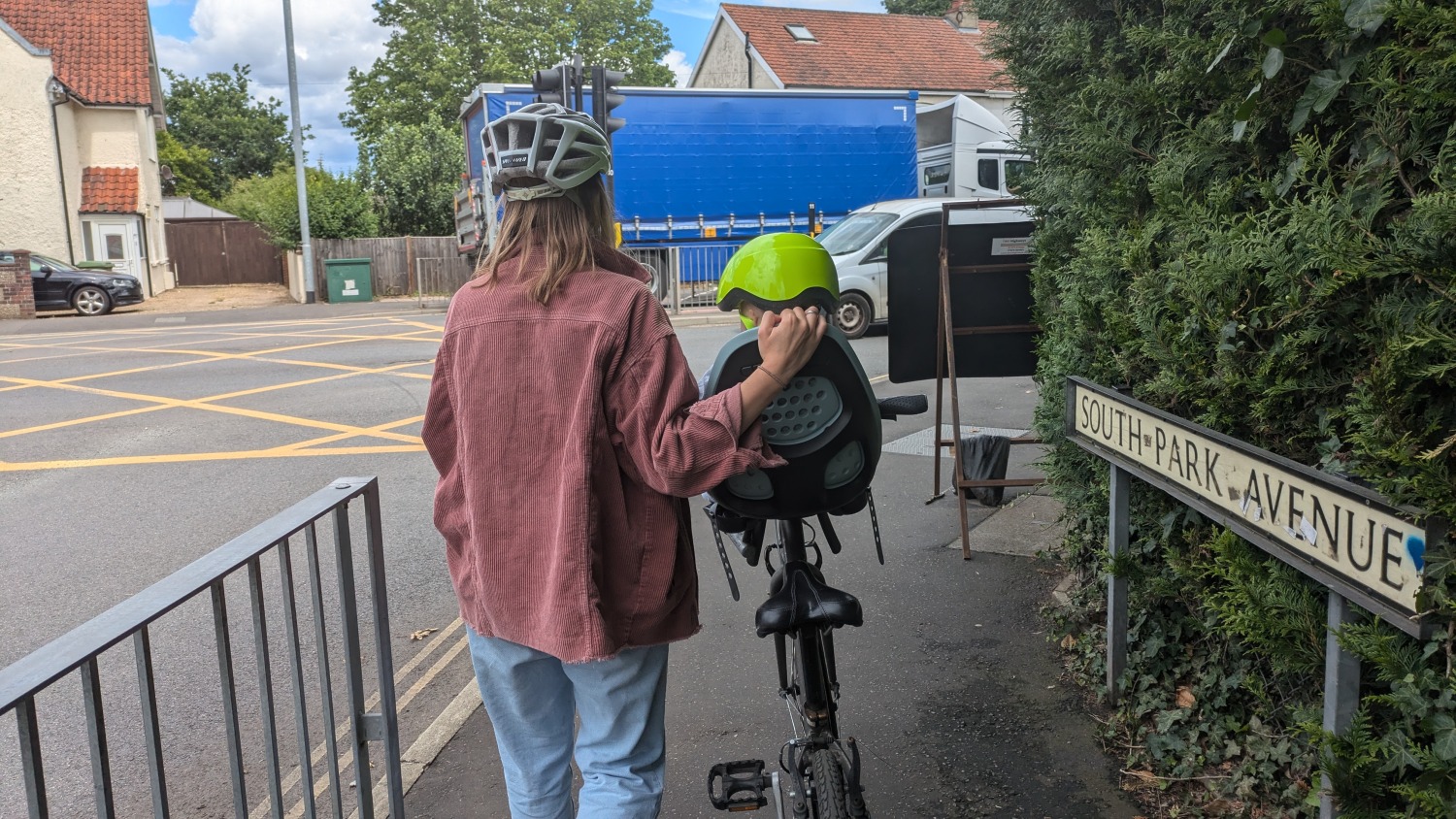 Parent with adult bike with front seat on it with toddler in it