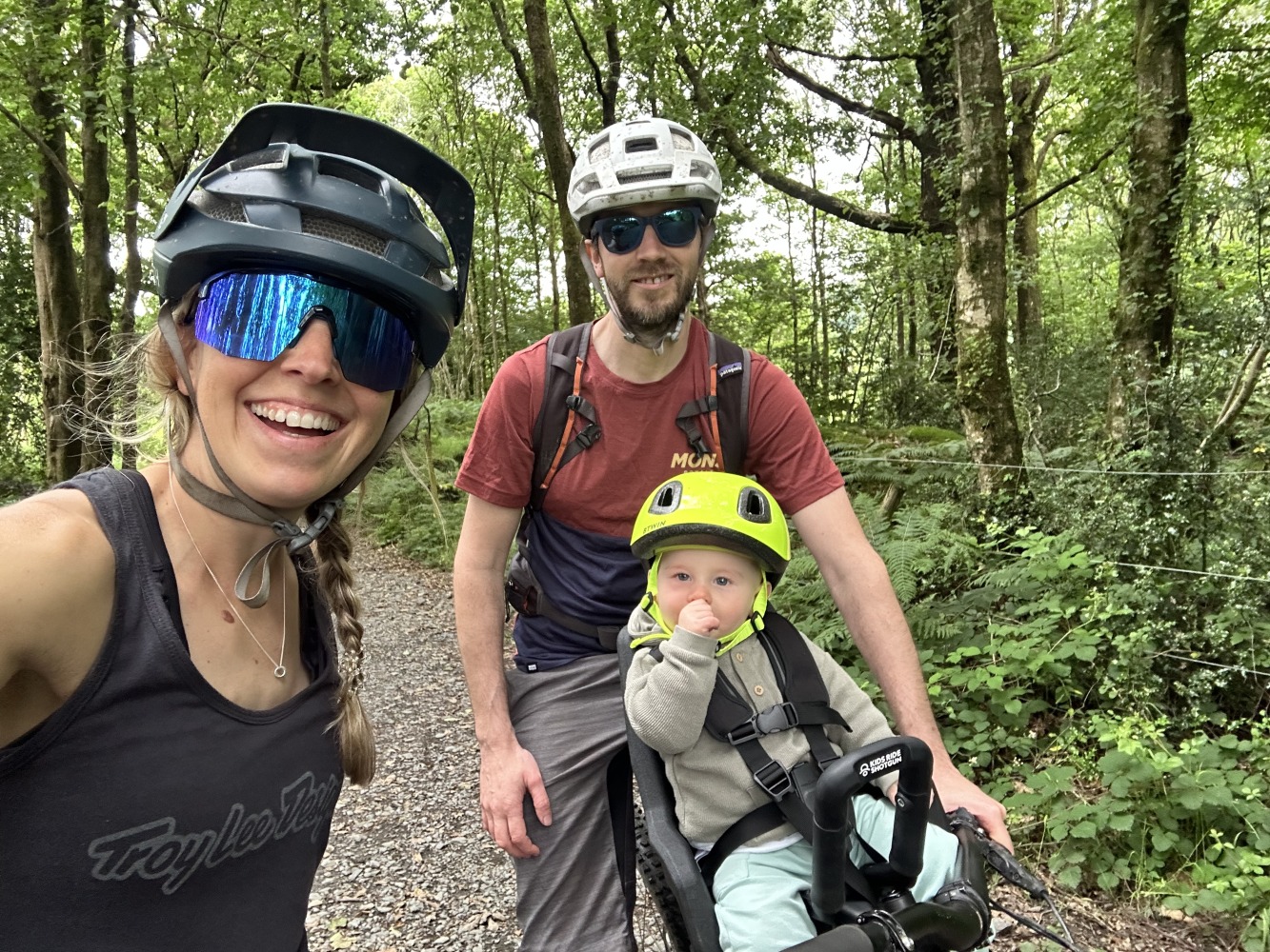 a selfie of a family with their son in the kids ride shotgun pro evo seat