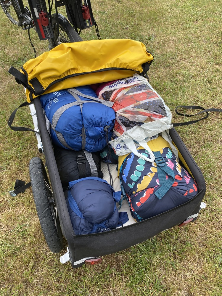 the yellow and black Burley Nomad cargo trailer filled with camping equipment