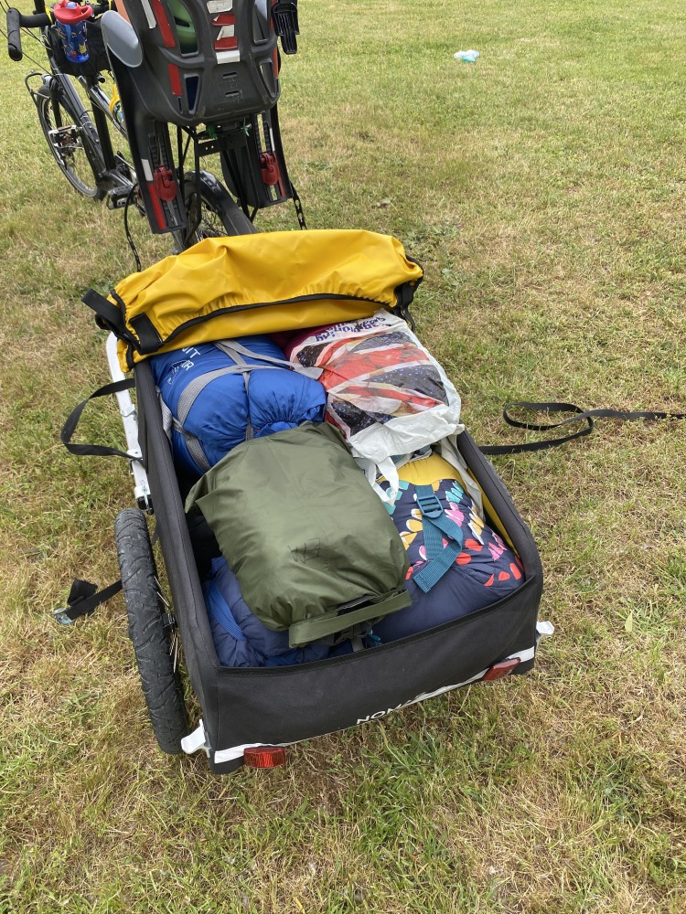 the yellow and black Burley Nomad cargo trailer filled with camping equipment