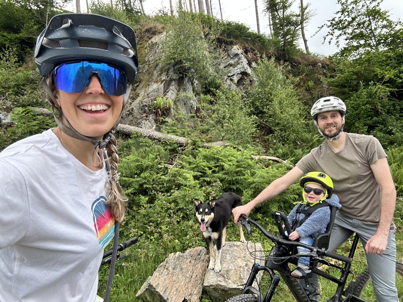 a selfie of a family with their son in the kids ride shotgun pro evo seat