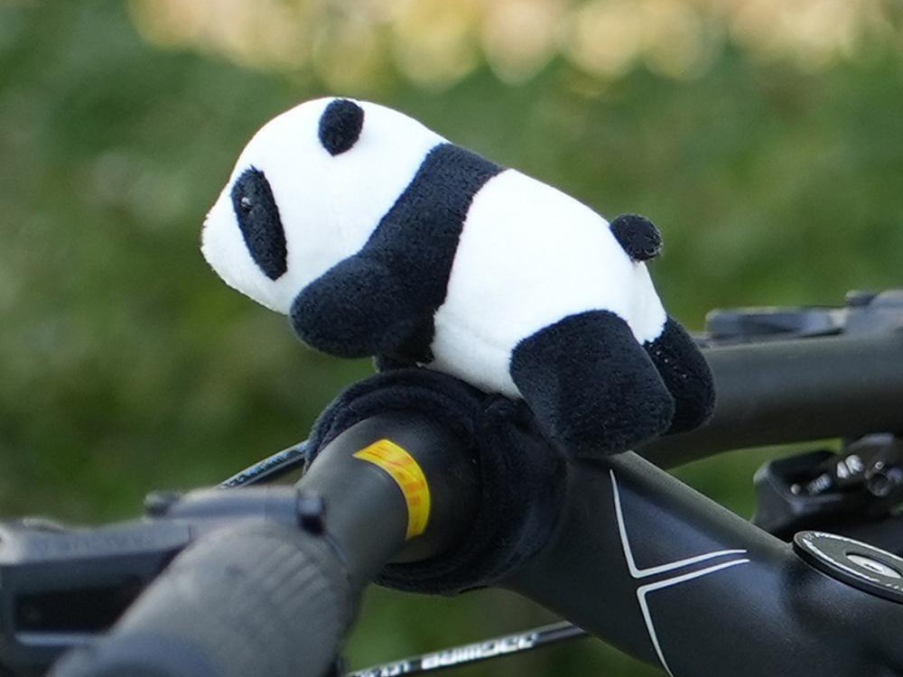 Best bike accessories for kids: A panda plushie affixed to a handlebar