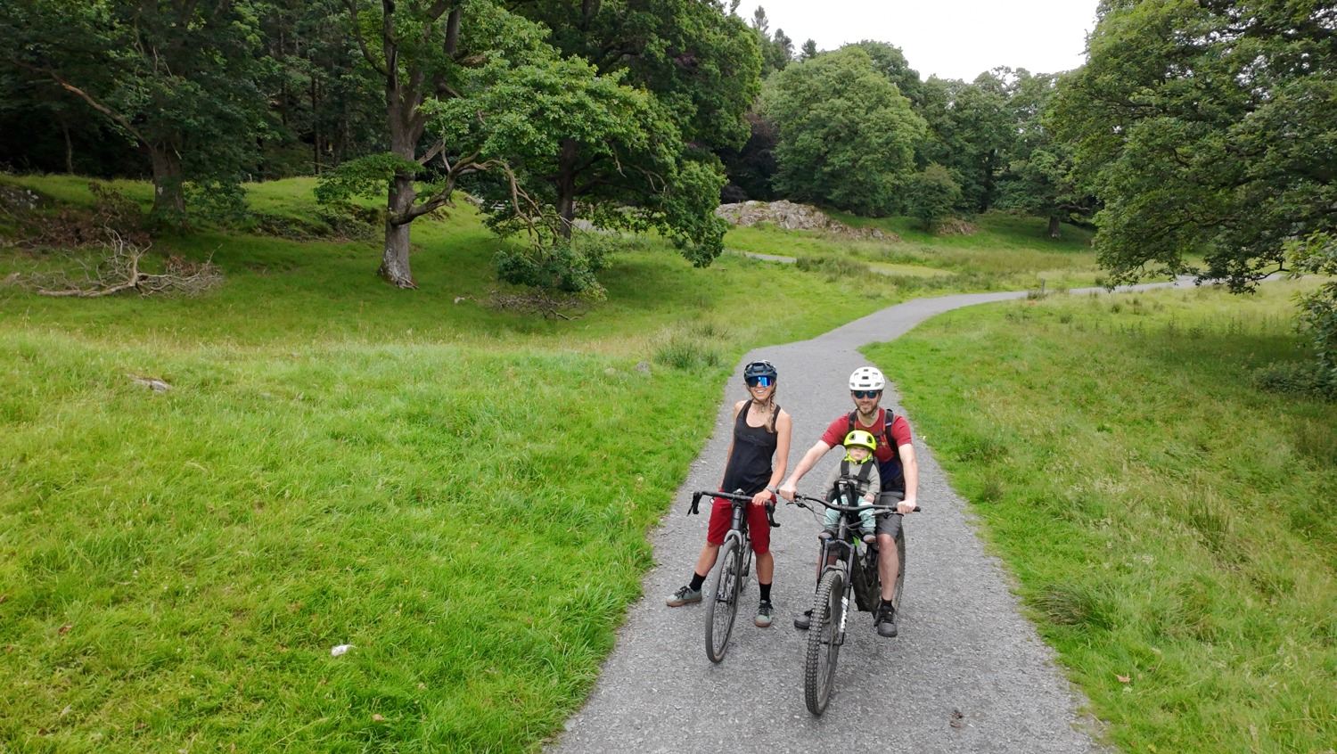 a selfie of a family with their son in the kids ride shotgun pro evo seat