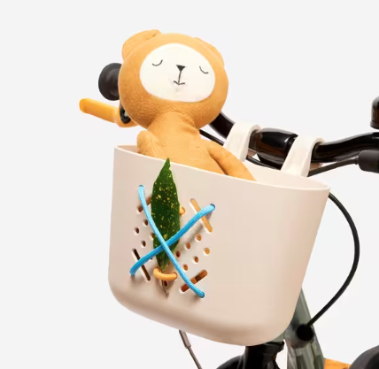 Best bike accessories for kids: A plastic bike basket mounted to a kids bike, holding a teddy bear
