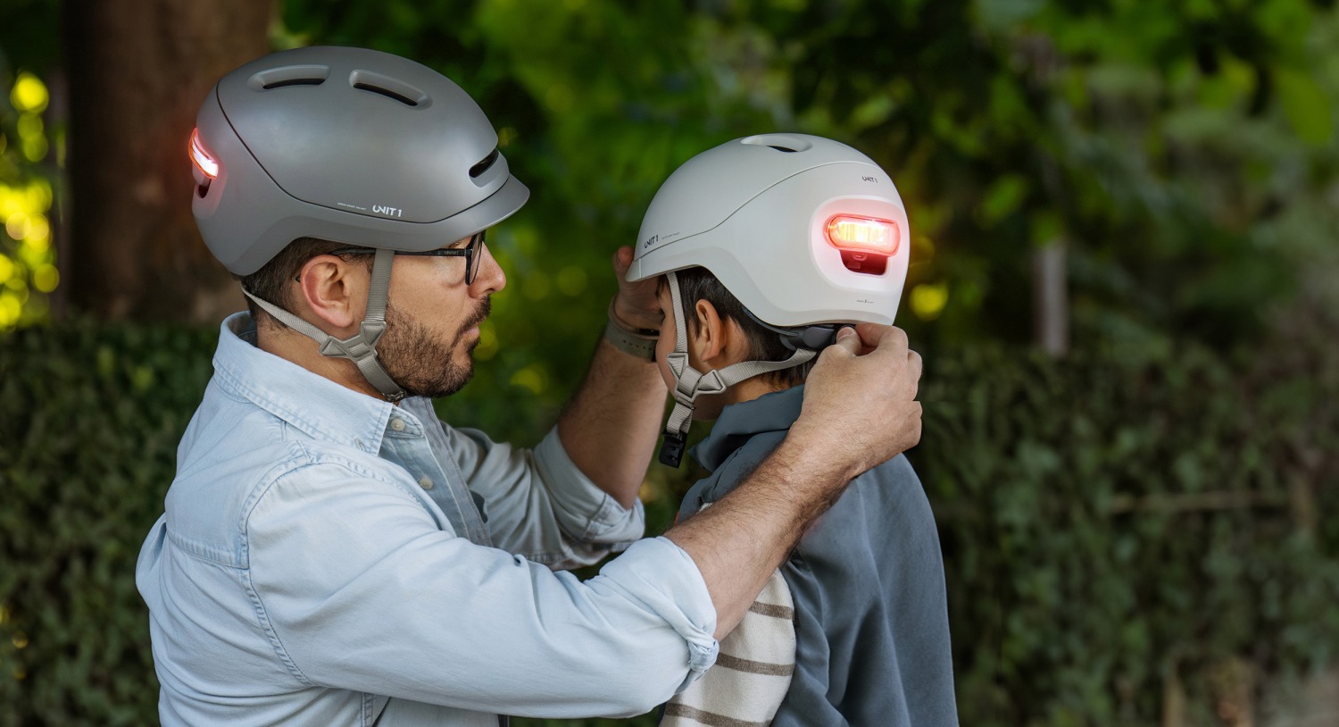 A dad adjusting his son's new SPARKY helmet