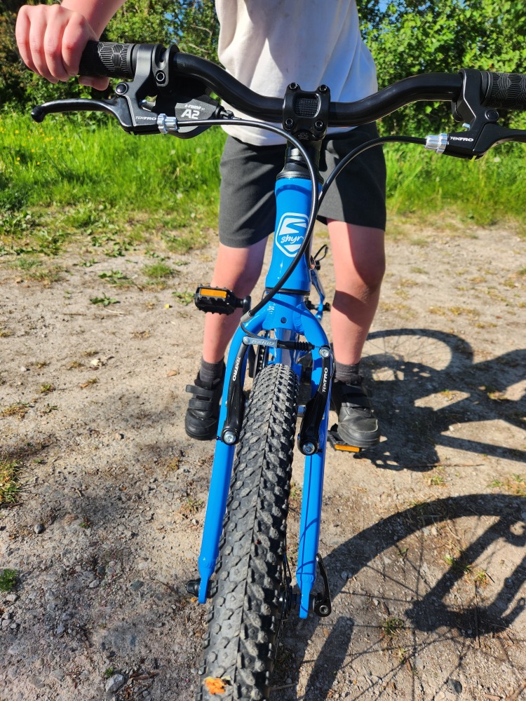 Shyre Hopton 20 review: The bike seen from the front, with a little boy standing over it