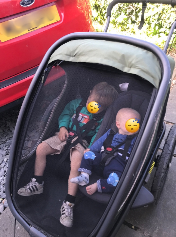 A family review of the hamax outback double trailer- two boys napping