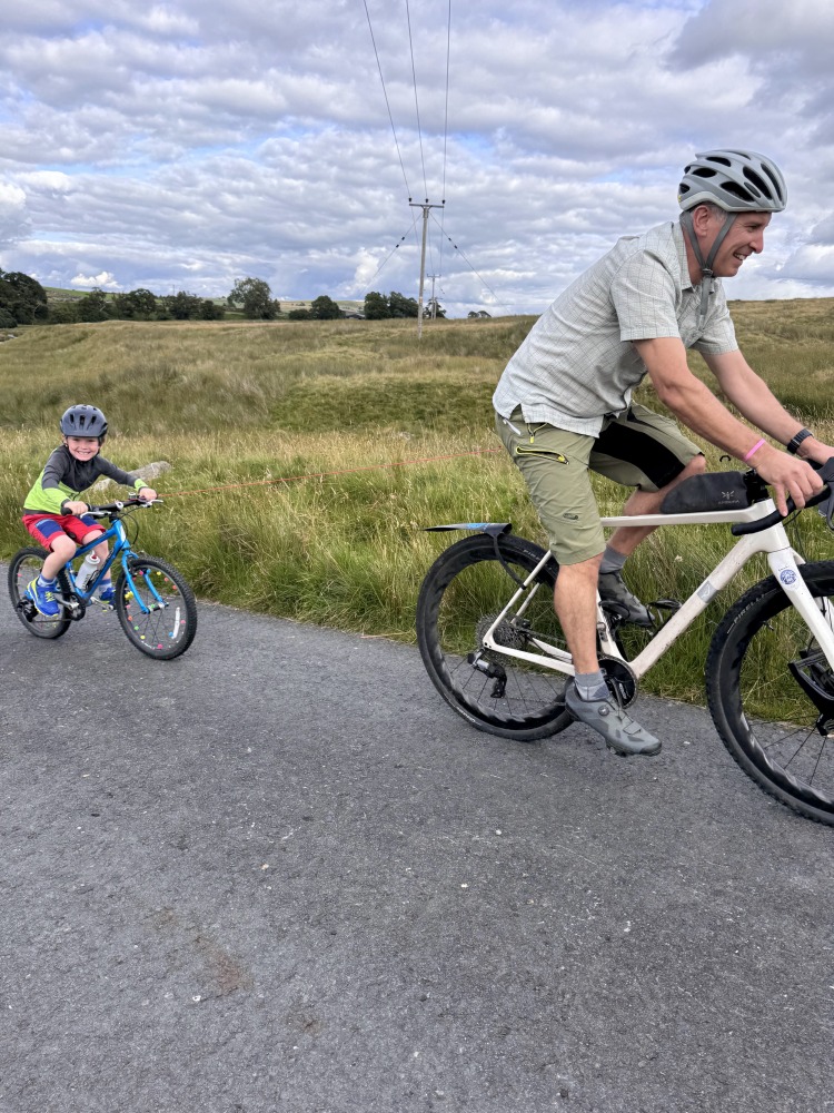 dad and son riding uphill with the Zefal Bike Taxi tow rope review