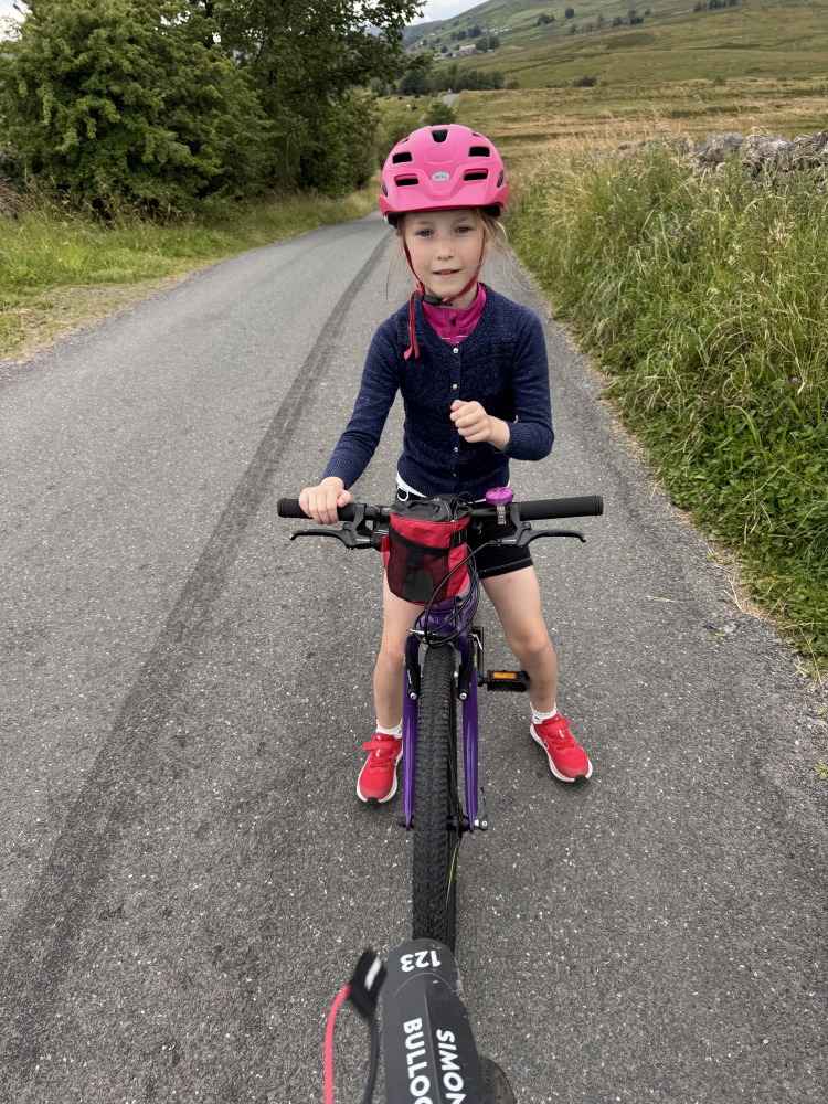 Zefal Bike Taxi tow rope review, a girl in a pink helmet holding the tow rope
