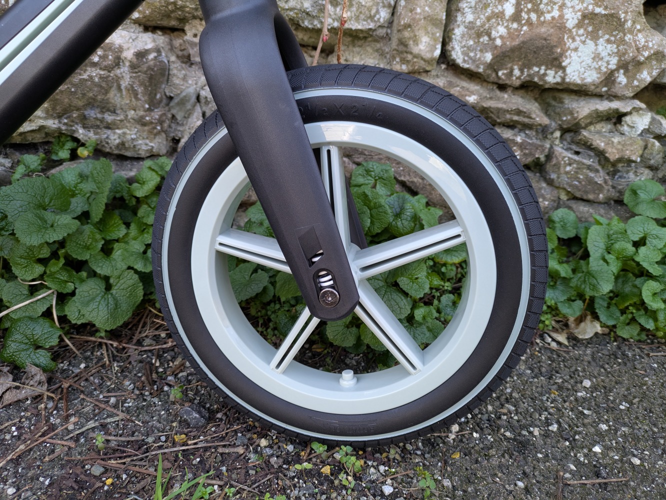 A blue and black Be Fun wheels folding balance bike, a close up of the front wheel