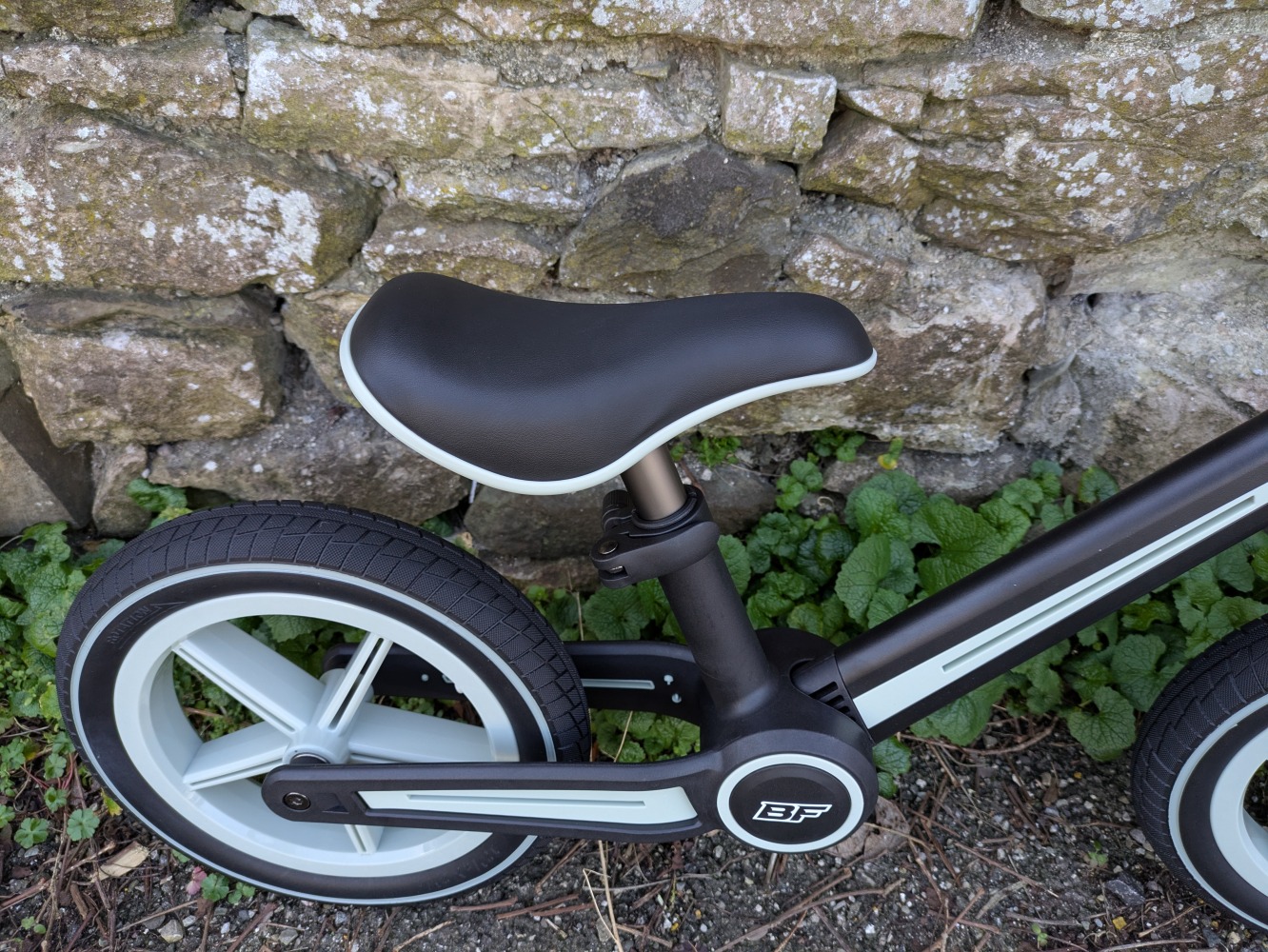 A blue and black Be Fun wheels folding balance bike, a close up of the saddle