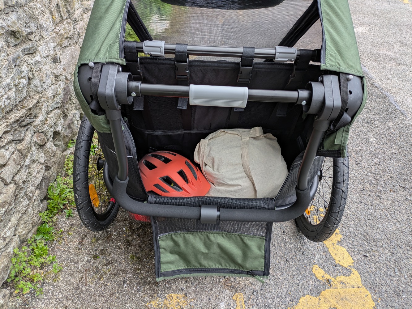 A green Hamax Outback double trailer- a close up of the storage