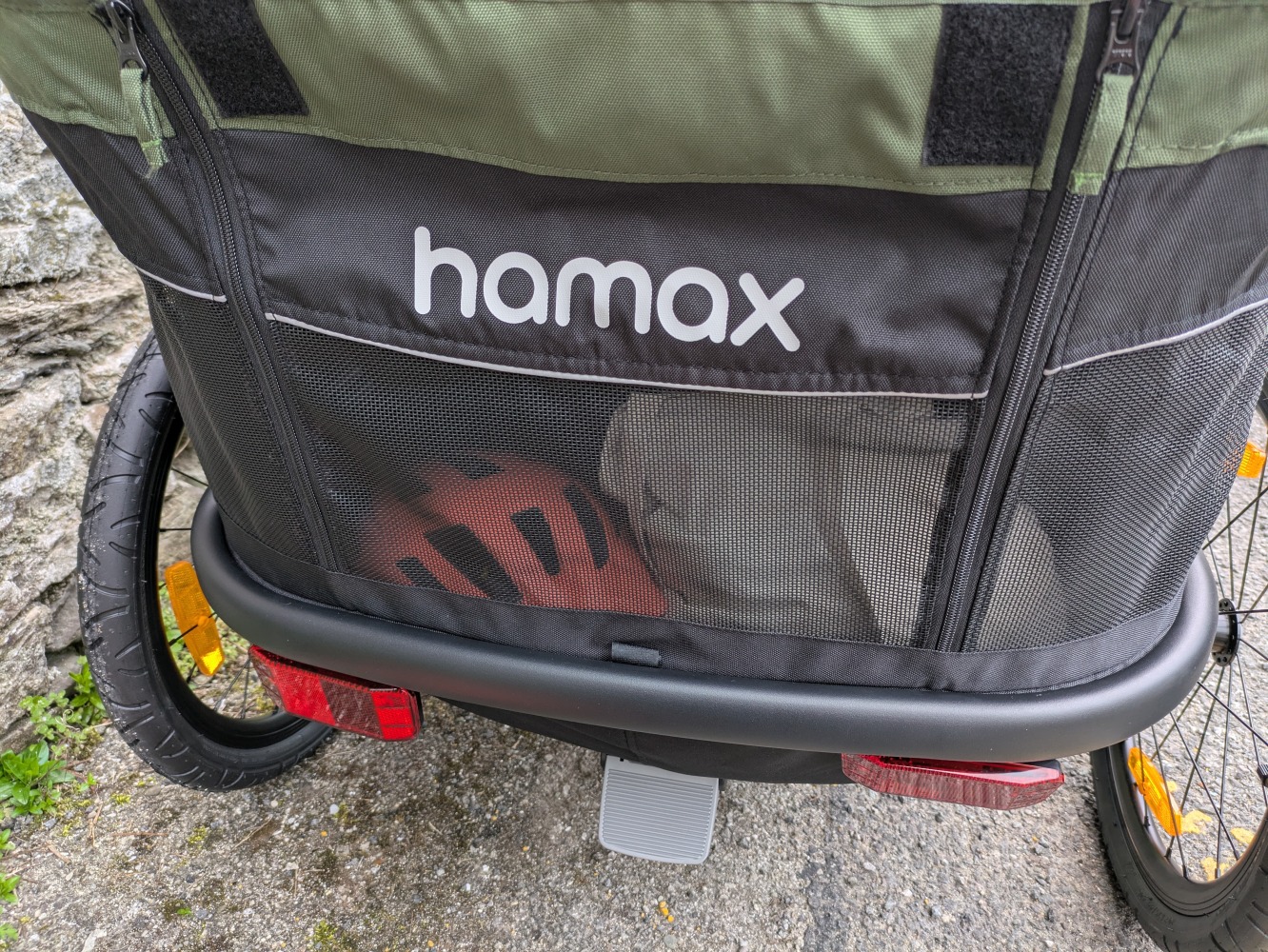A green Hamax Outback double trailer- a close up of the rear storage