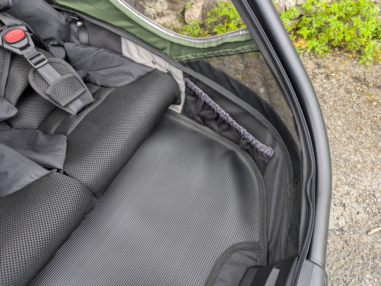 A green Hamax Outback double trailer- a close up of the two footwell