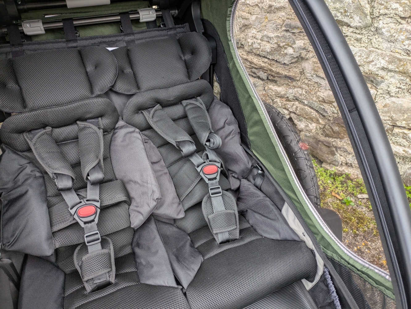 A green Hamax Outback double trailer- a close up of the two seats