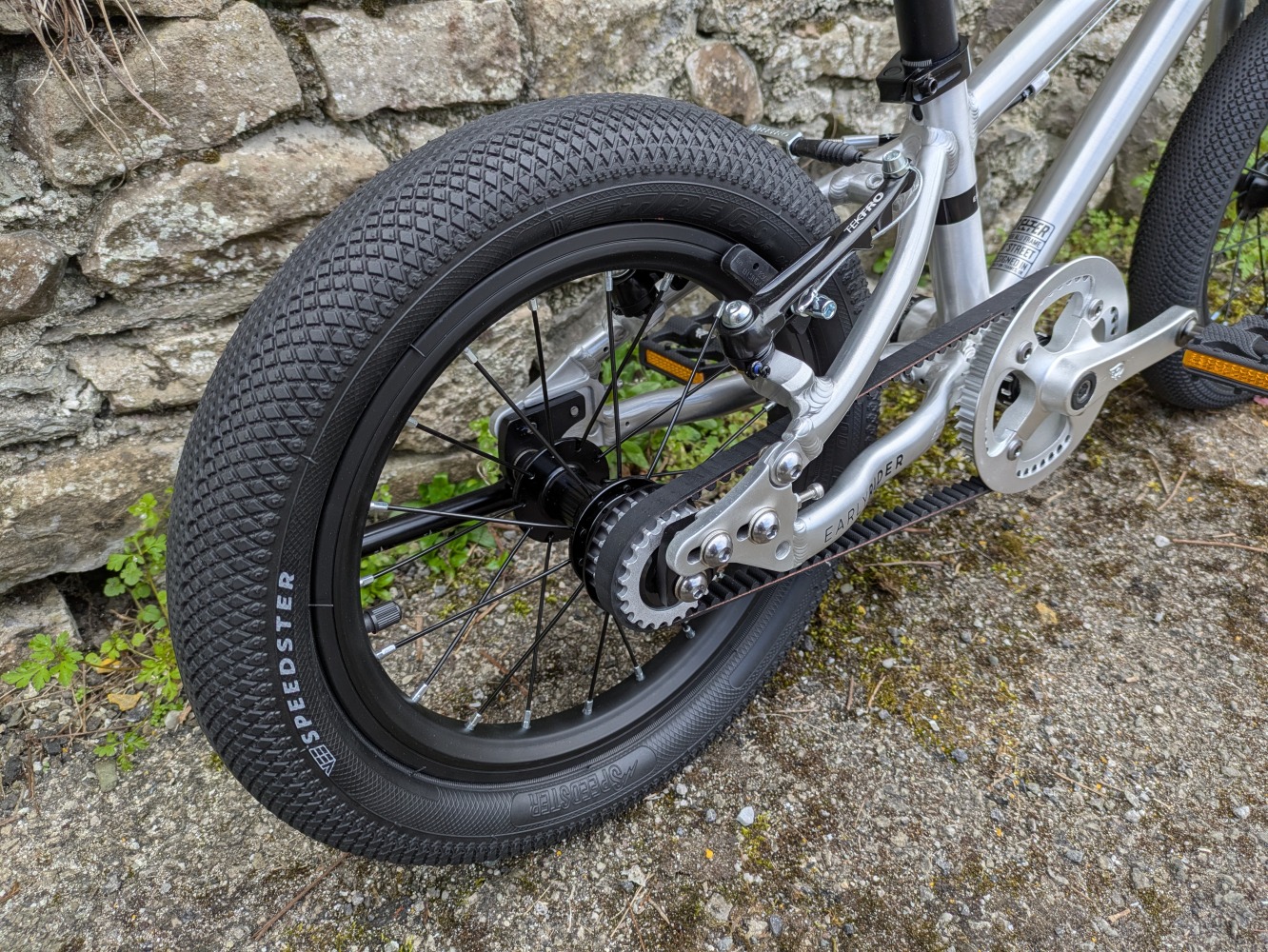 A close up of the rear wheel on the silver, early rider belter- cycle sprog rider review