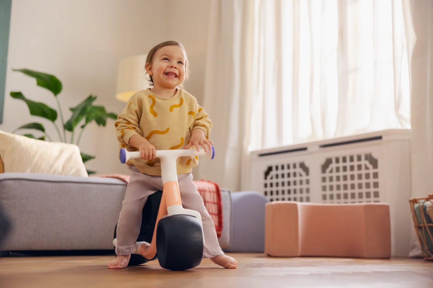 a stock image of the woom wow, being ridden by a toddler