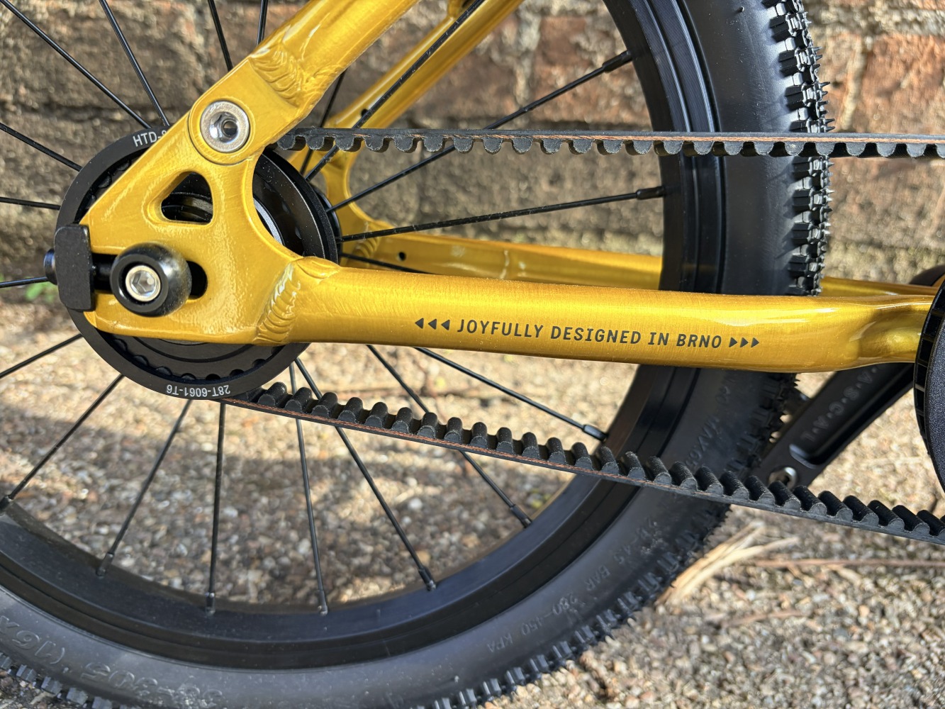 A close up photo of a yellow framed Rascal kids bike with a Gates Carbon belt drive